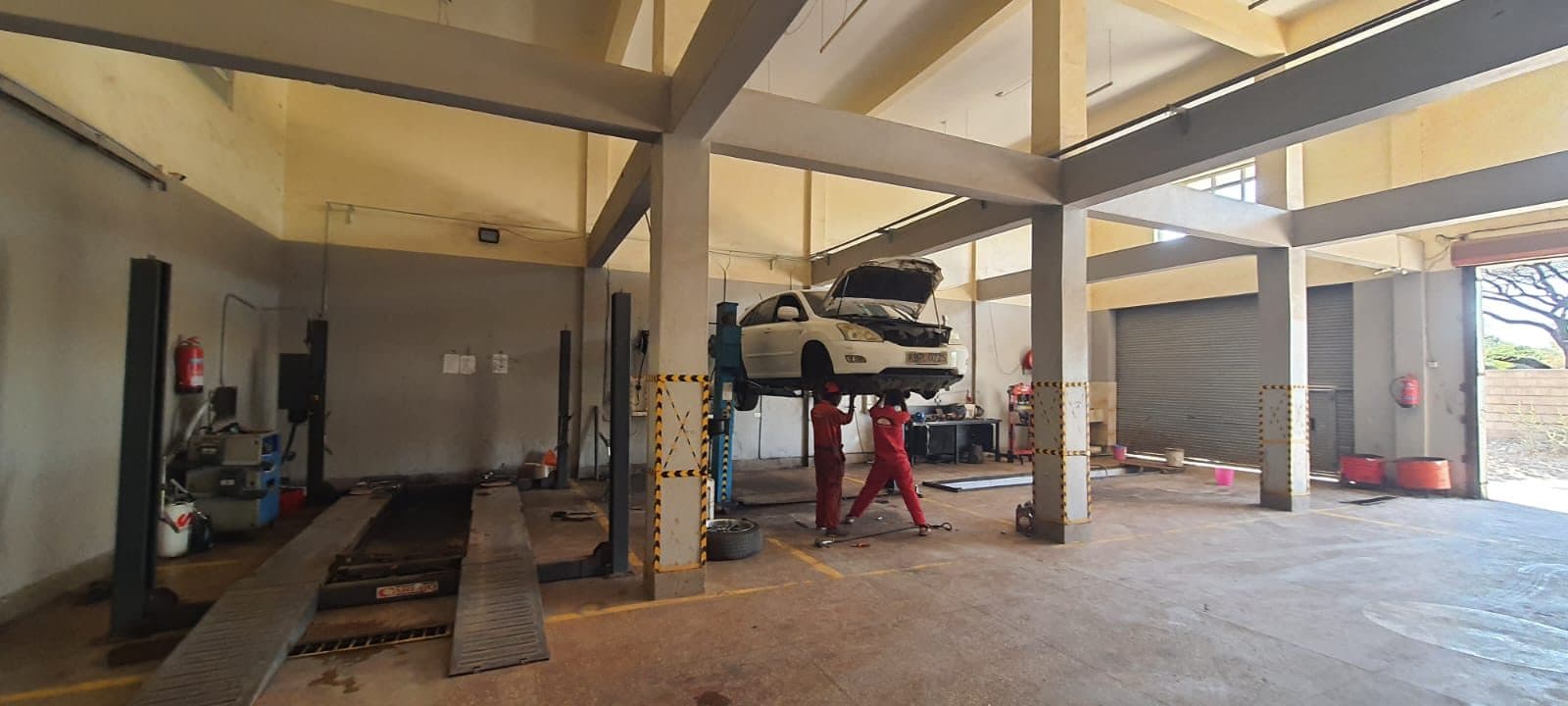 Mechanics servicing a Lexus RX on a two-post lift inside the Parkside Garage workshop